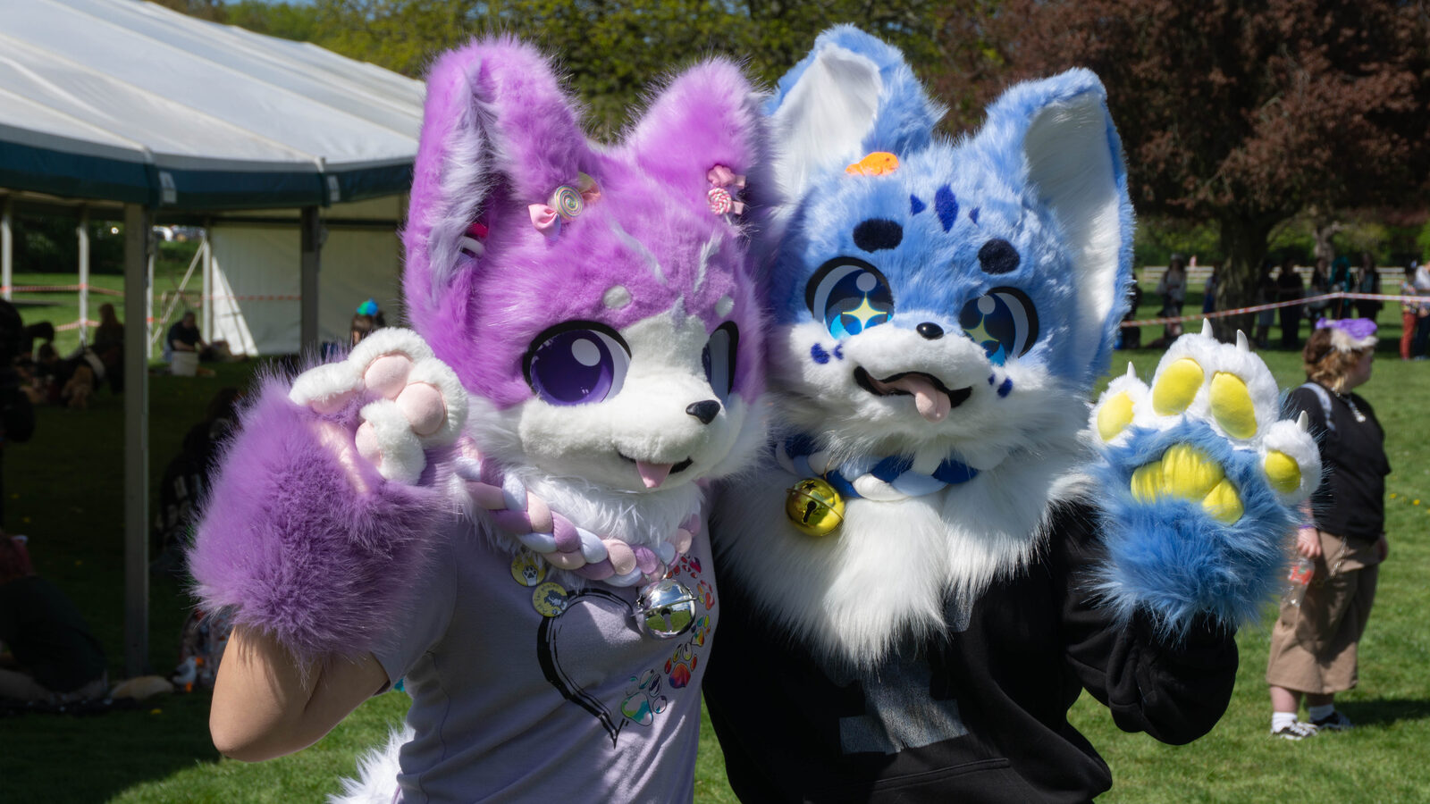 Two fursuiters posing happily at a Pups in the Park event